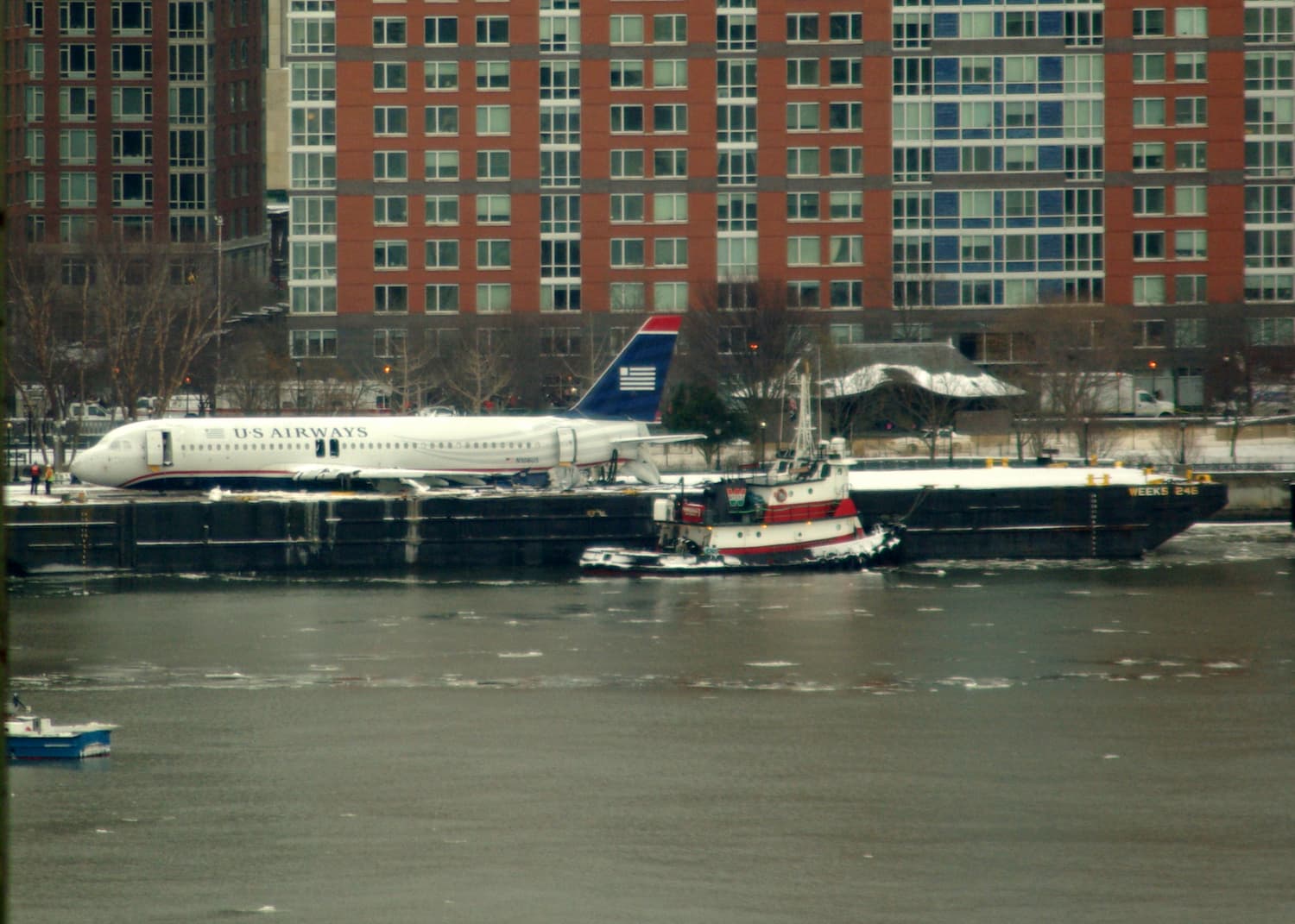 Image shows Flight 1549 resting on a barge after being removed from the Hudson River