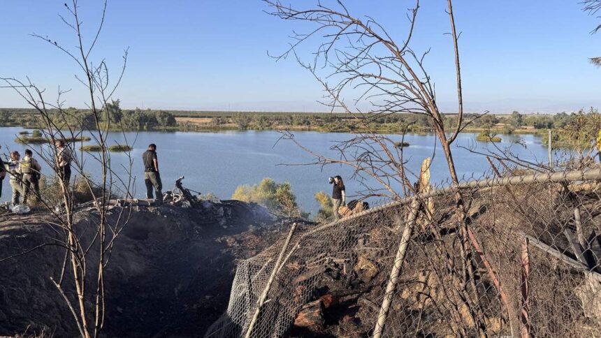Emergency crews are pictured at the scene of the crash, overlooking the San Joaquin River on a sunny day.