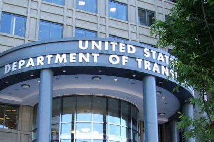 The headquarters of the U.S. Department of Transportation in Washington. The department’s name is written in gold letters, in front of grey stone.