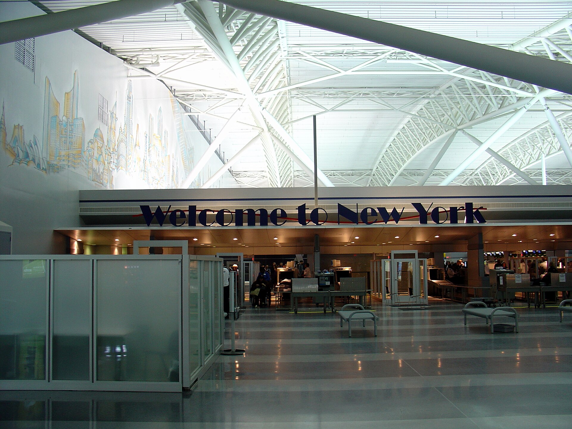Terminal 9 at John F. Kennedy International Airport (JFK). A sign reads “Welcome To New York”.