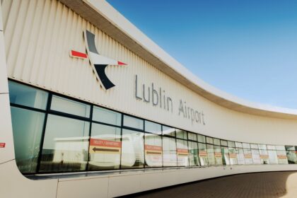The terminal building at Lublin Airport (LUZ). The building is made of white stone, with clear windows, beneath a clear blue sky.