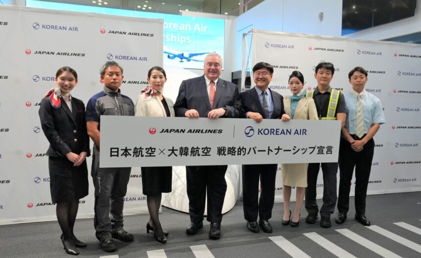 A meeting for the joint declaration of strategic partnership on september 3. Those involved stand in a line holding an award plaque declaring the partnership.