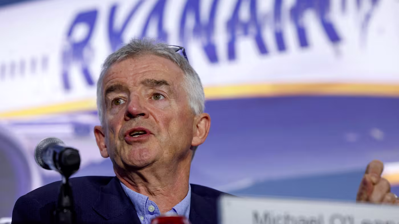 Ryanair CEO Michael O'Leary is pictured speaking on front of a projected screen of a Ryanair aircraft.