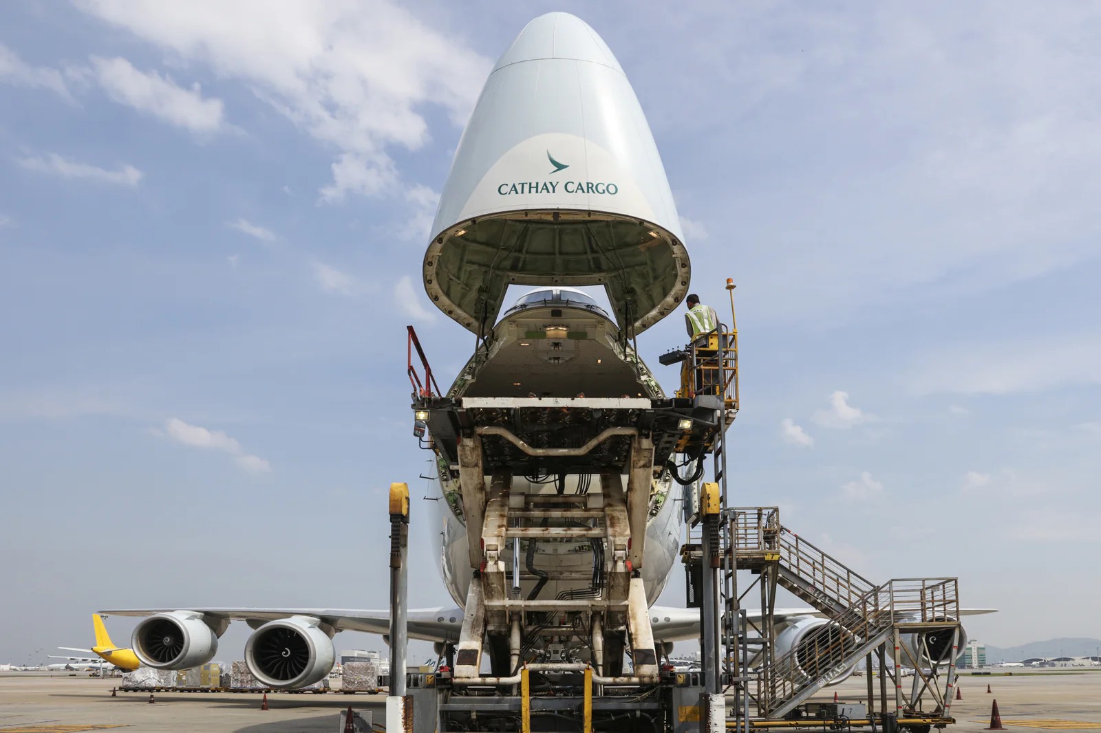 A image of a front view of a Cathay Cargo Boeing 747 freighter with its nose door hinged upward