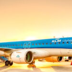 Photogtaphd depicting a KLM Cityhopper Embraer aircraft on the airport runway to mark 60 years of KLM Cityhopper network.