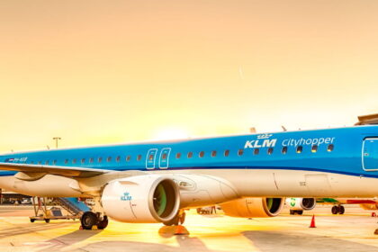 Photogtaphd depicting a KLM Cityhopper Embraer aircraft on the airport runway to mark 60 years of KLM Cityhopper network.