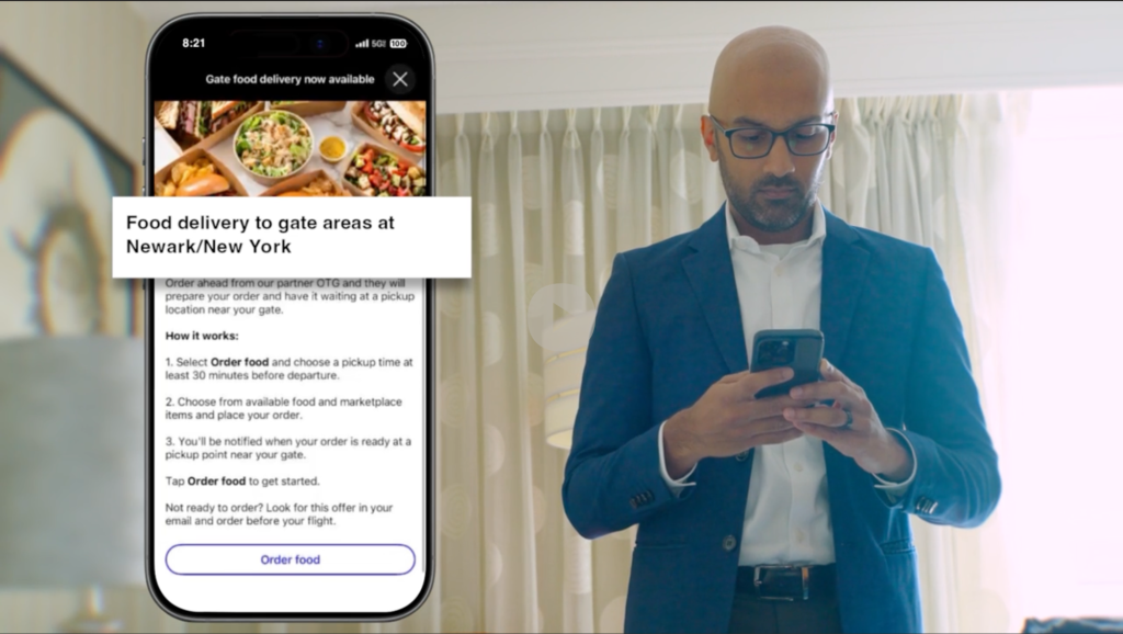 A man in a suit looking down at his smartphone, alongside an enlarged screen mockup of the United Airlines mobile app displaying an offer for