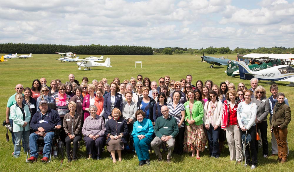 This is a large outdoor group photograph of the BWPA members taken at an airfield