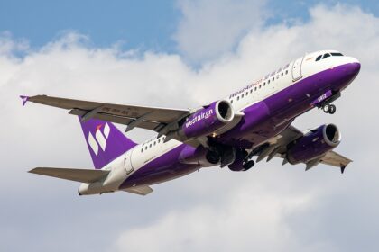 Full view of West Air's Airbus A319-133 with its landing gear extended.