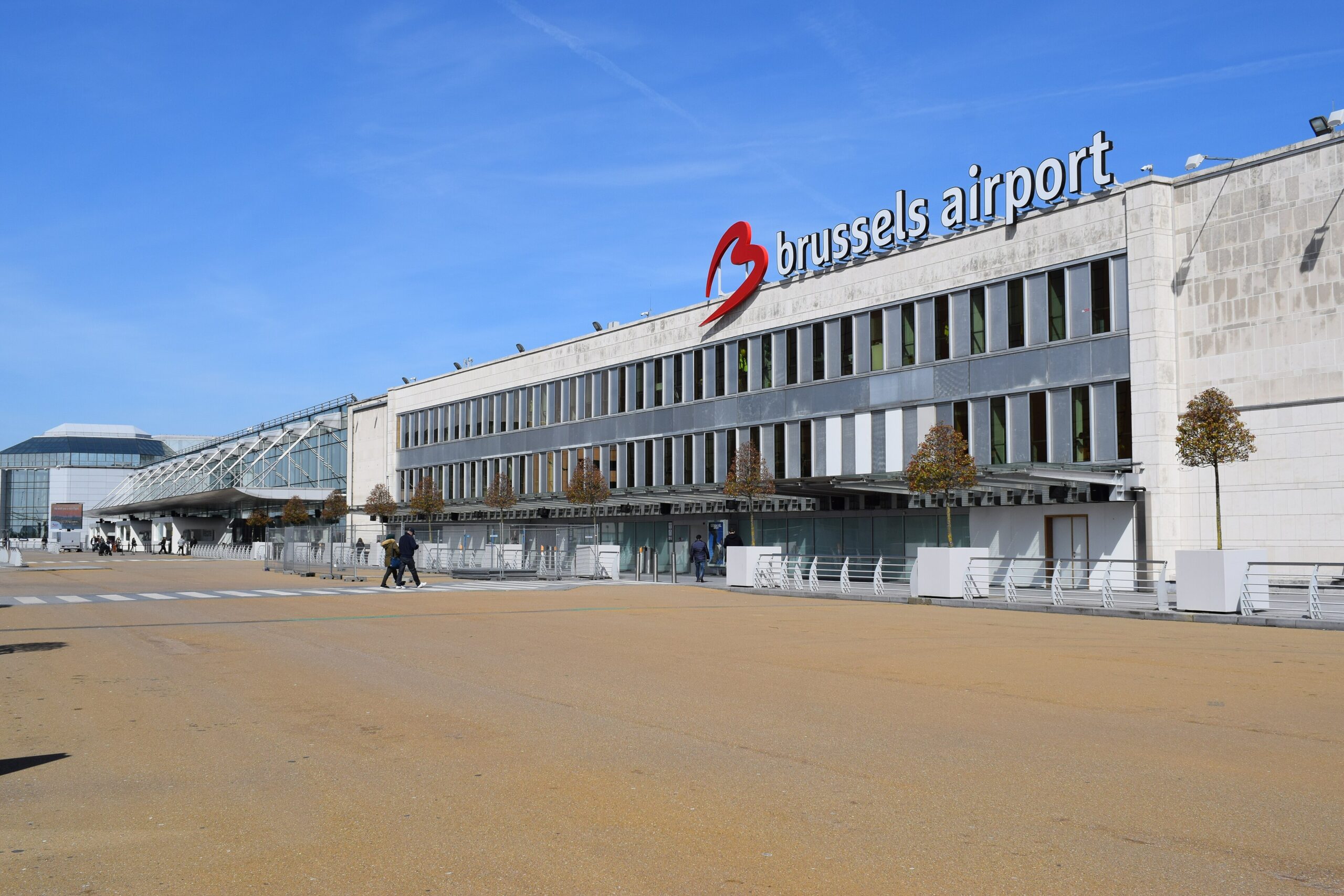 The façade of the Brussels Airport exterior terminal, showing a red heart shape next to the written 'brussels Airport' text