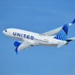 United Airlines plane flying in the blue sky
