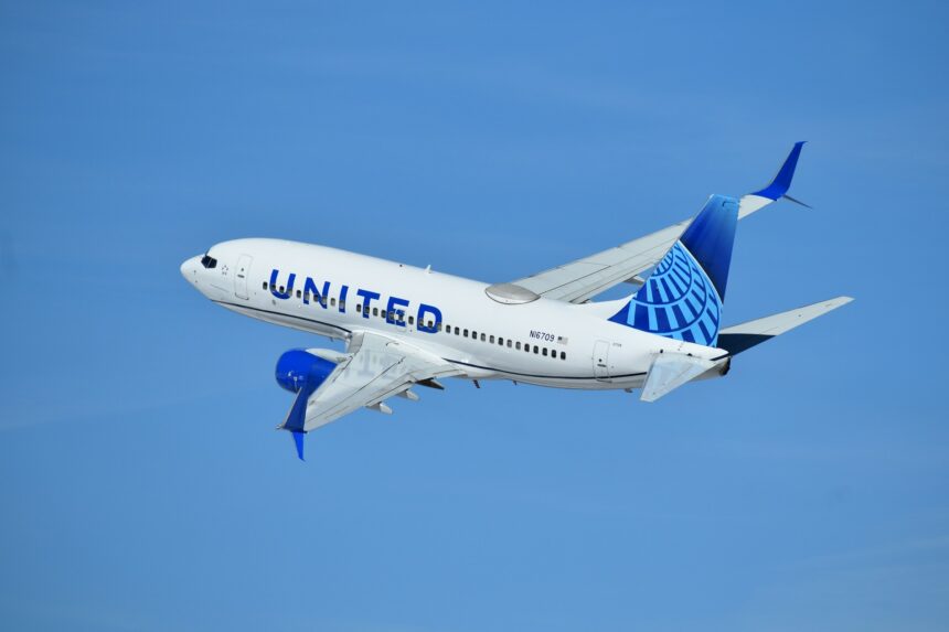 United Airlines plane flying in the blue sky