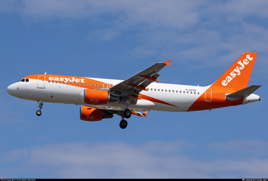 An easyJet Airbus A320 approaching an airport with its landing gear lowered