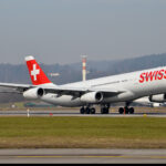 Photograph depicting Swiss Airbus A340 taking off from the airport runway.