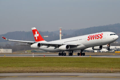 Photograph depicting Swiss Airbus A340 taking off from the airport runway.