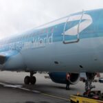 A light blue jet sat on a runway at London Heathrow Airport (LHR).