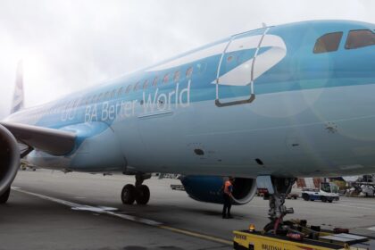 A light blue jet sat on a runway at London Heathrow Airport (LHR).