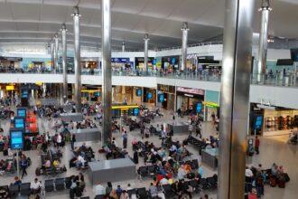 Lots of passengers inside of an airport in Heathrow (LHR).