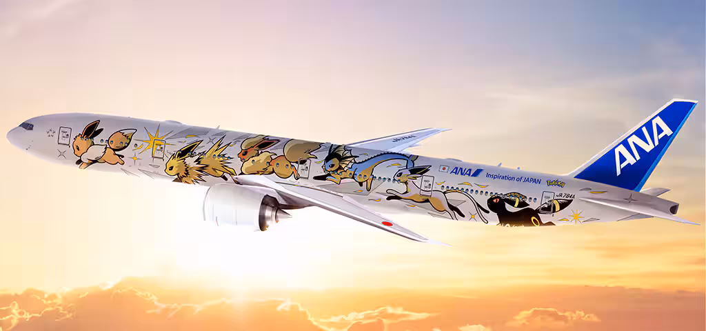An ANA plane flying above the clouds, with the Pokémon Eevee displayed on the exterior design. The sun is setting in the background.
