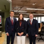 Image shows Qantas' new innovation centre in Adelaide with SA Premier Peter Malinauskas, Qantas Group Chief Technology, AI and Transformation Officer Rachel Yangoyan and Minister Chris Picton smiling to camera