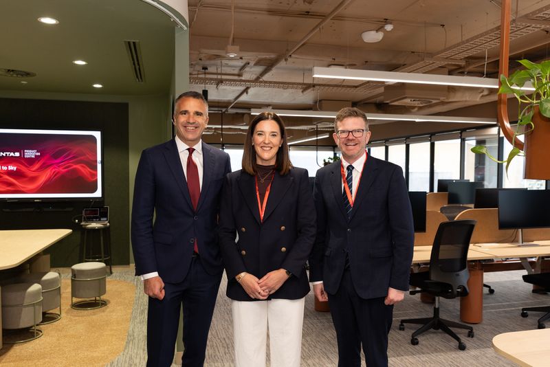 Image shows Qantas' new innovation centre in Adelaide with SA Premier Peter Malinauskas, Qantas Group Chief Technology, AI and Transformation Officer Rachel Yangoyan and Minister Chris Picton smiling to camera