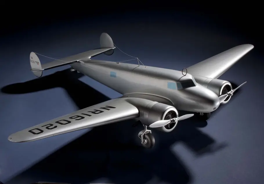 A model of the Lockheed Electra, a silver aircraft against a blue background 