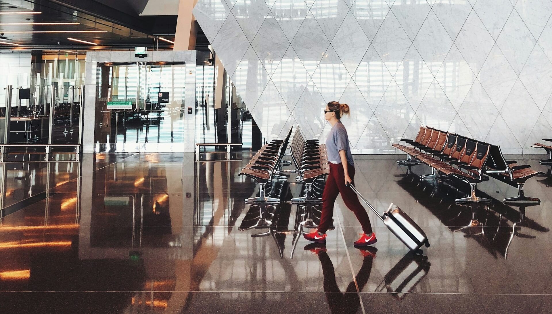 Passenger walking through airport carrying a luggage