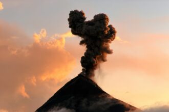 Volcano emitting ash cloud during eruption