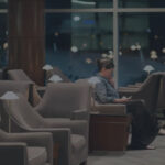 Photograph depicting a woman relaxing at a Star Alliance airport lounge.