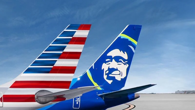 Close up photo of the wings of an American Airlines plane, one of them visually detailing the American flag.