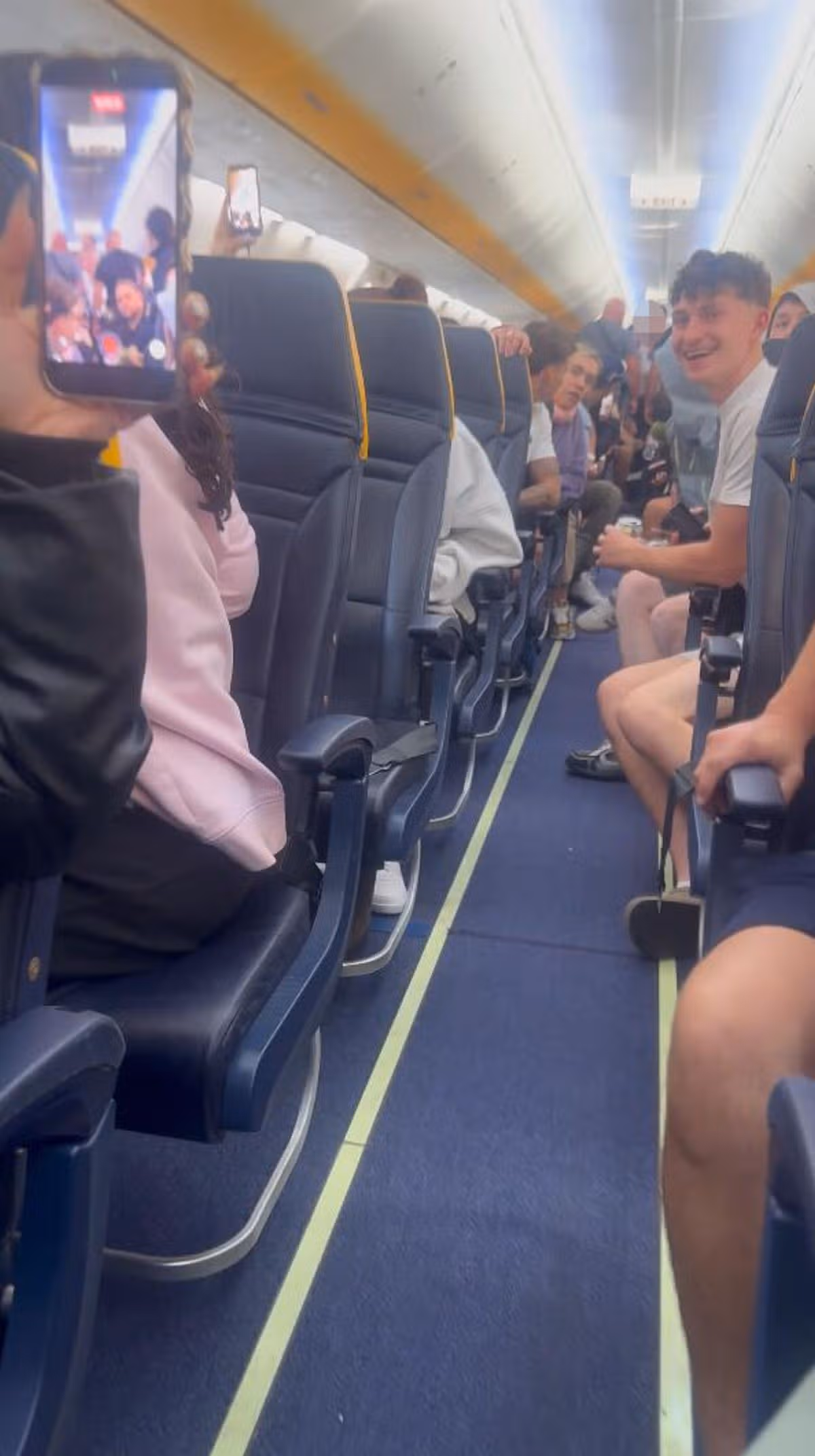 Passengers on the Ryanair flight witnessing the fight in the aisle at the back of the aircraft.