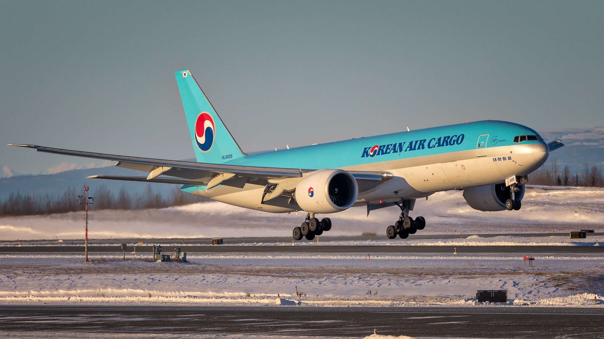 A aircraft with blue fuselage taking off