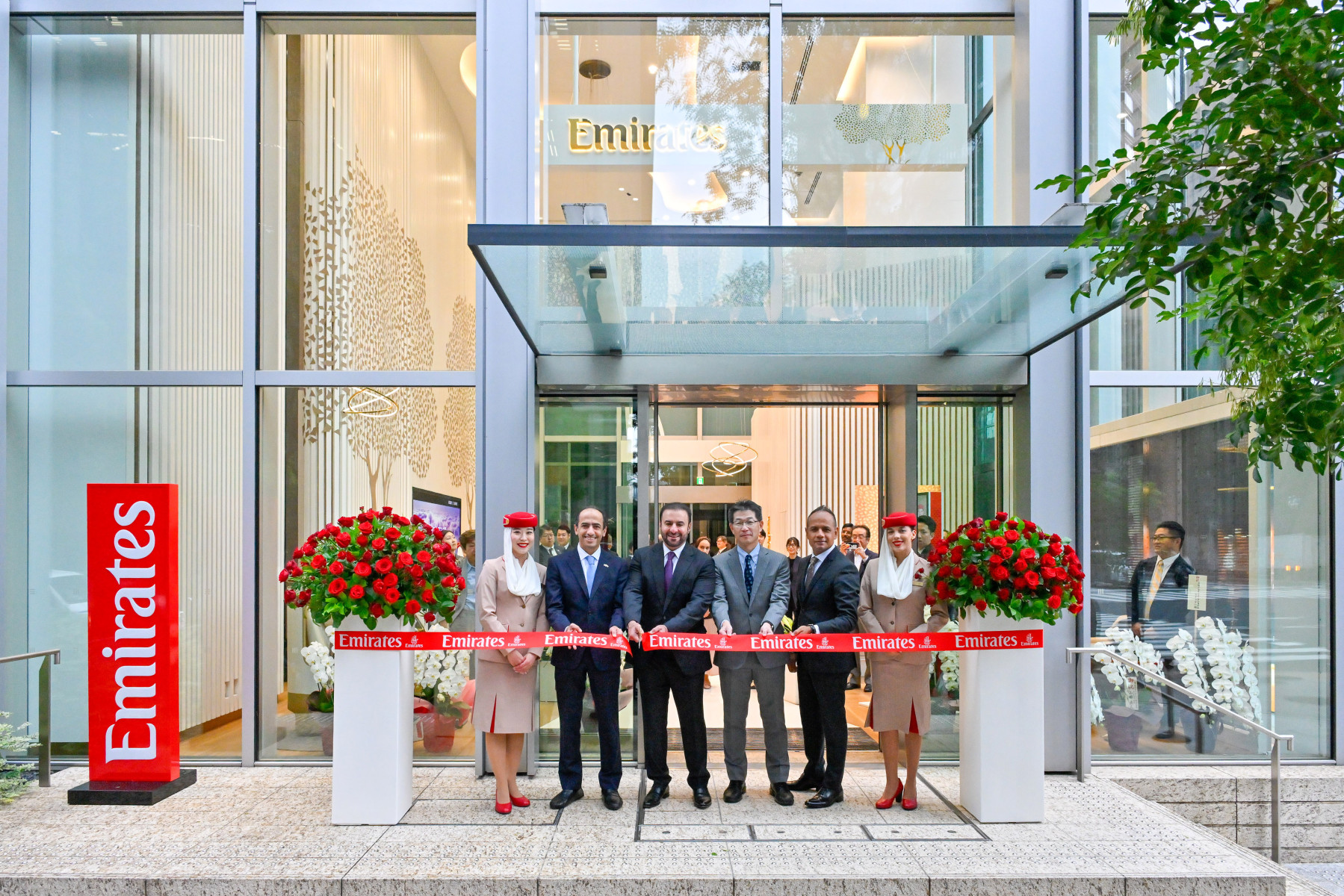 Photograph depicting the ribbon cutting ceremony to mark the opening of the new Tokyo travel store in Japan.