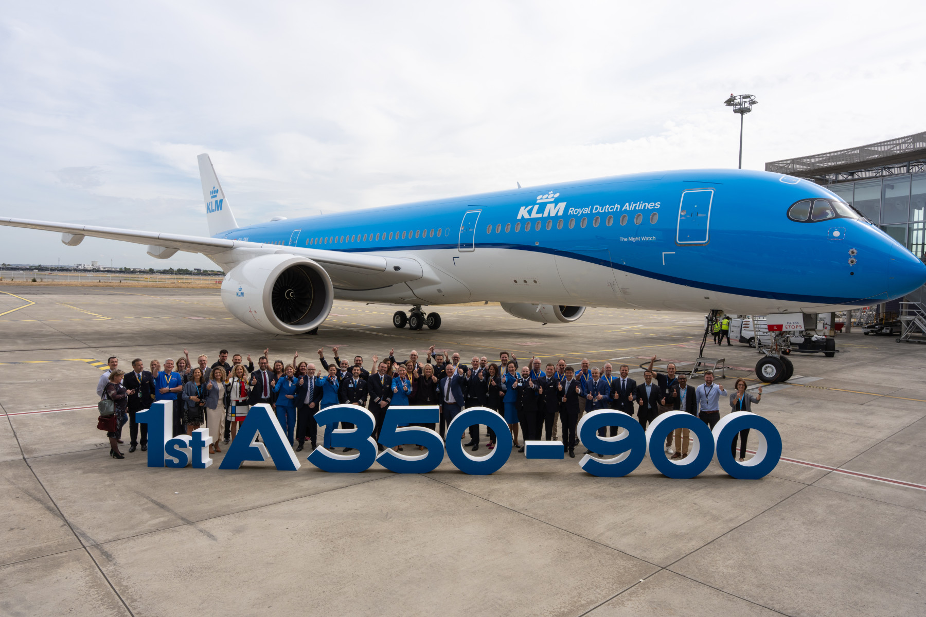 Photograph depicting the A350-900 on the runway with KLM staff celebrating the aircraft's arrival.