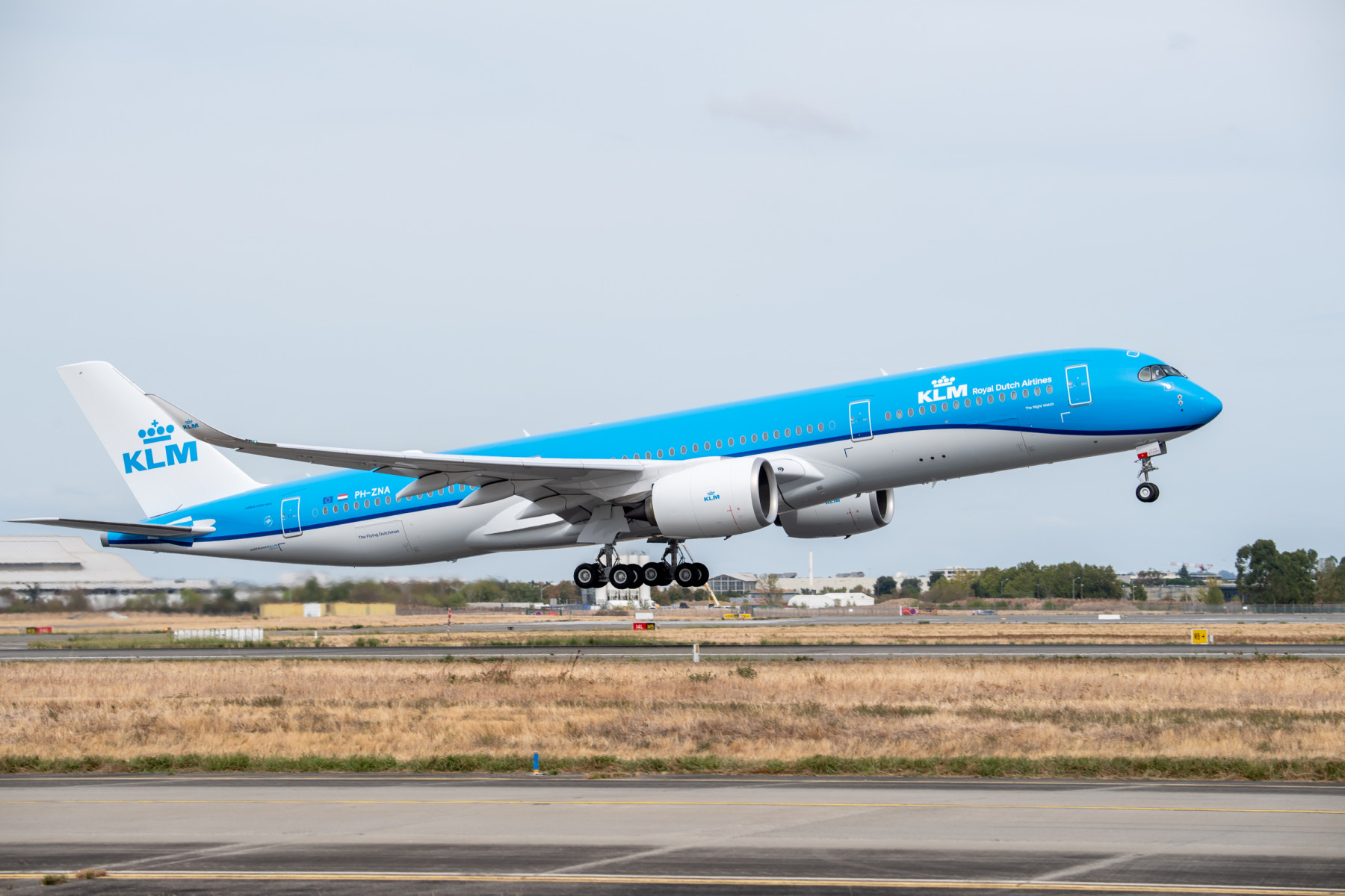Photograph depicting a KLM A350-900 aircaft at take off on the runway.