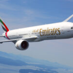 Photograph depicting Emirates' Boeing 777 flying above the clouds.