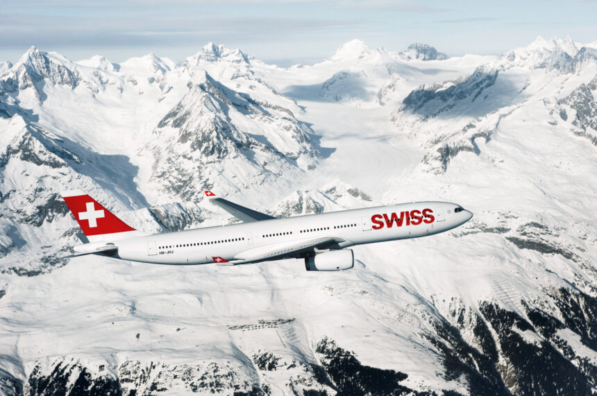 Photograph depicting a SWISS Airbus A330-300 flying above a snowy and mountainous landscape.