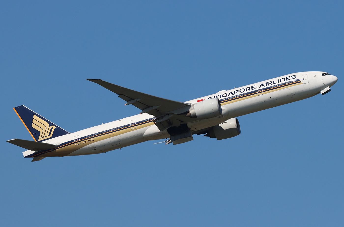 A Singapore Airlines Boeing 777-312ER taking off from Amsterdam Schiphol Airport with its landing gear retracted.