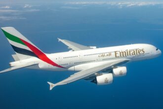 Photograph depicting Emirates A380 flying high above the clouds.