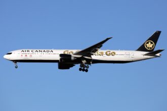 White aircraft flying against a cloudless blue sky