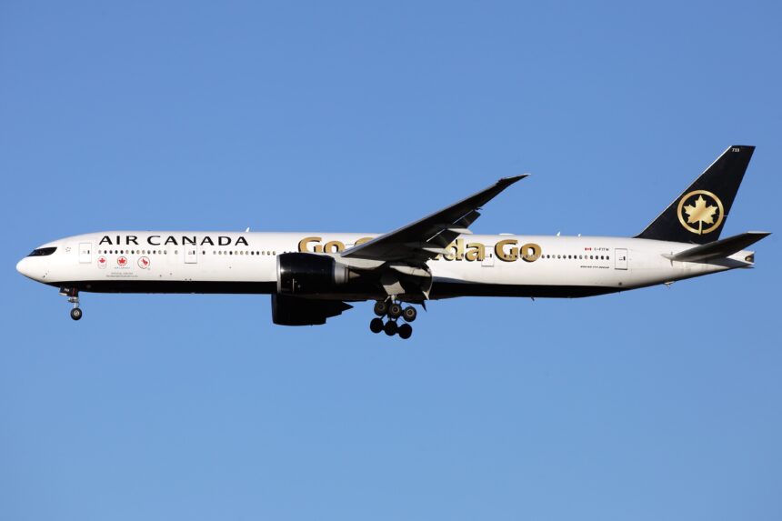 White aircraft flying against a cloudless blue sky