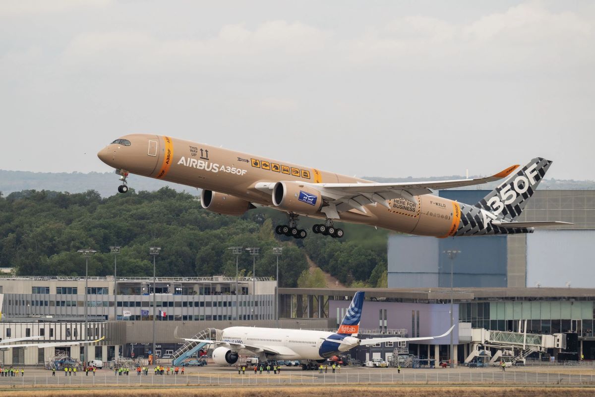 The freighter is taking off from France. It is coloured beige to mimic the look of a package parcel with yellow details that look like tape. The tail features black and grey zigzagged lines with white writing that announces the aircraft type - the A350F.