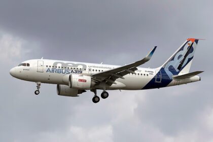 Image shows an Airbus aircraft in flight on a cloudy day