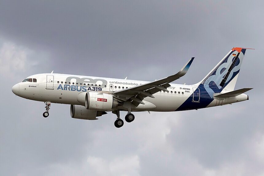 Image shows an Airbus aircraft in flight on a cloudy day