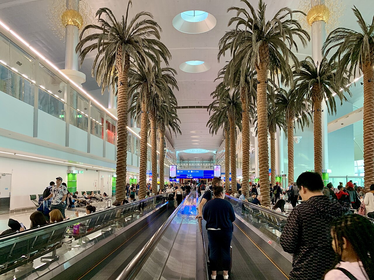 Passengers walking through Terminal 3 at Dubai International Airport