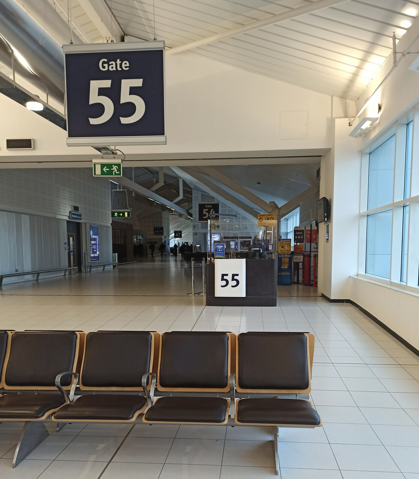 Empty seating area beside Gate 55 inside Birmingham Airport