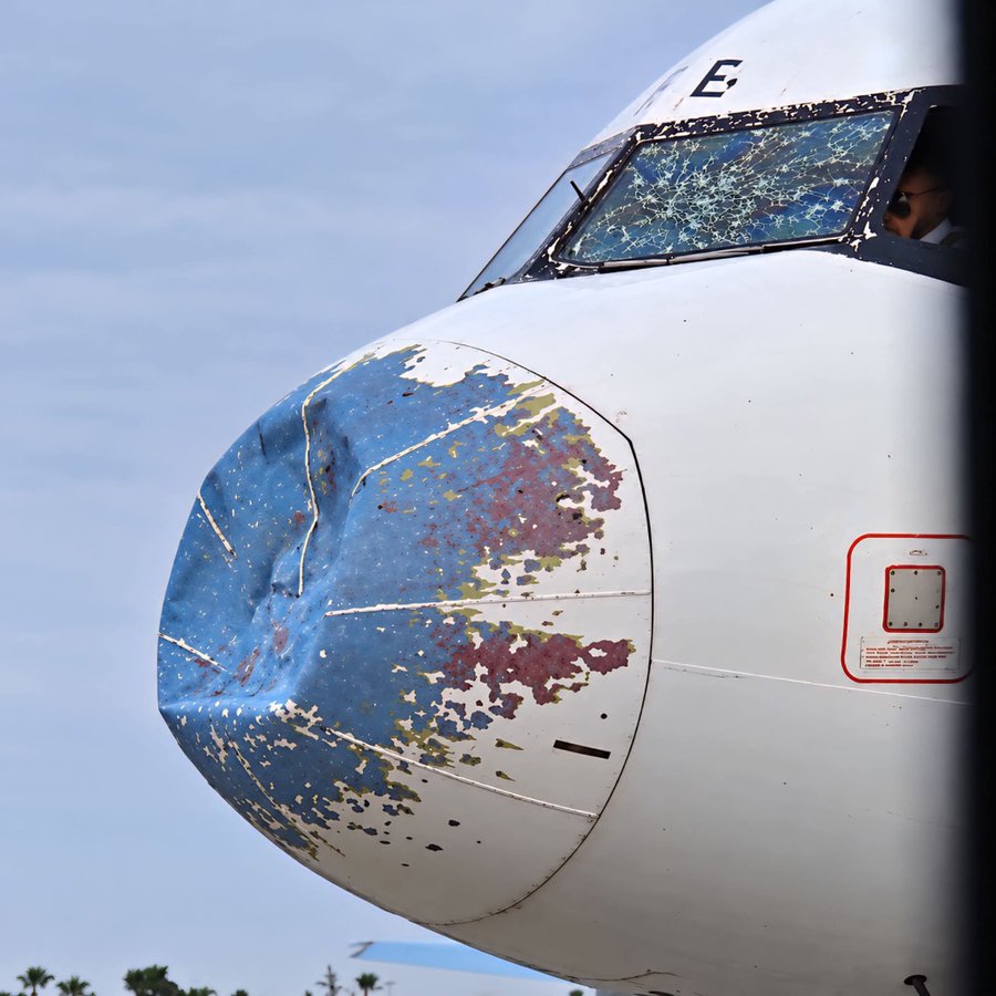 Damaged front of a Yemenia Airways aircraft, with a huge dent in the front of the aircraft.