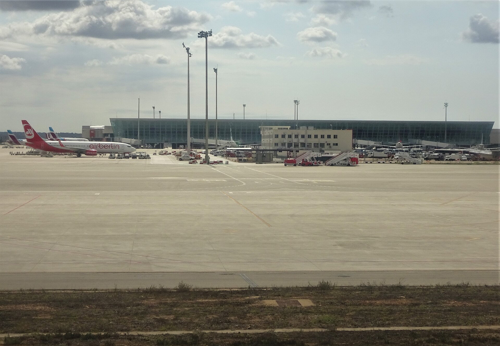Jets sat on the runway at PMI in Mallorca, a terminal building is visible behind.