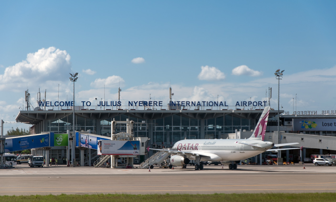 A white Qatar Airways jet sat in front of the terminal building at Julius Nyerere International Airport (DAR).