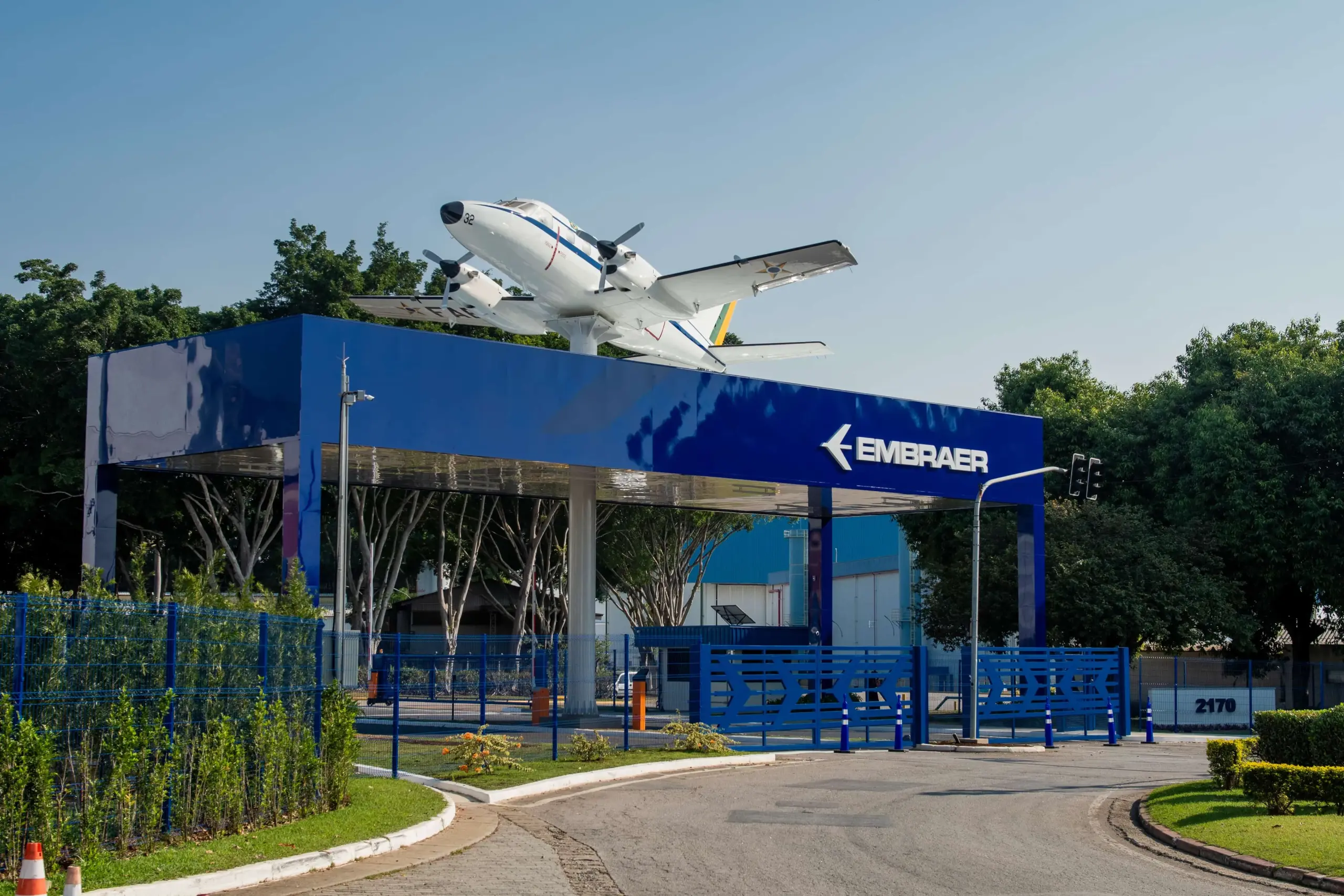 The entrance to Embraer’s Ozires Silva unit. A white model jet sits on top of a blue archway.